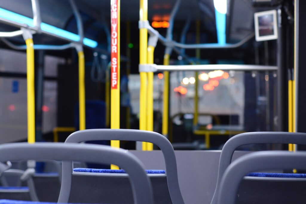 Empty bus with yellow "watch your step" poles