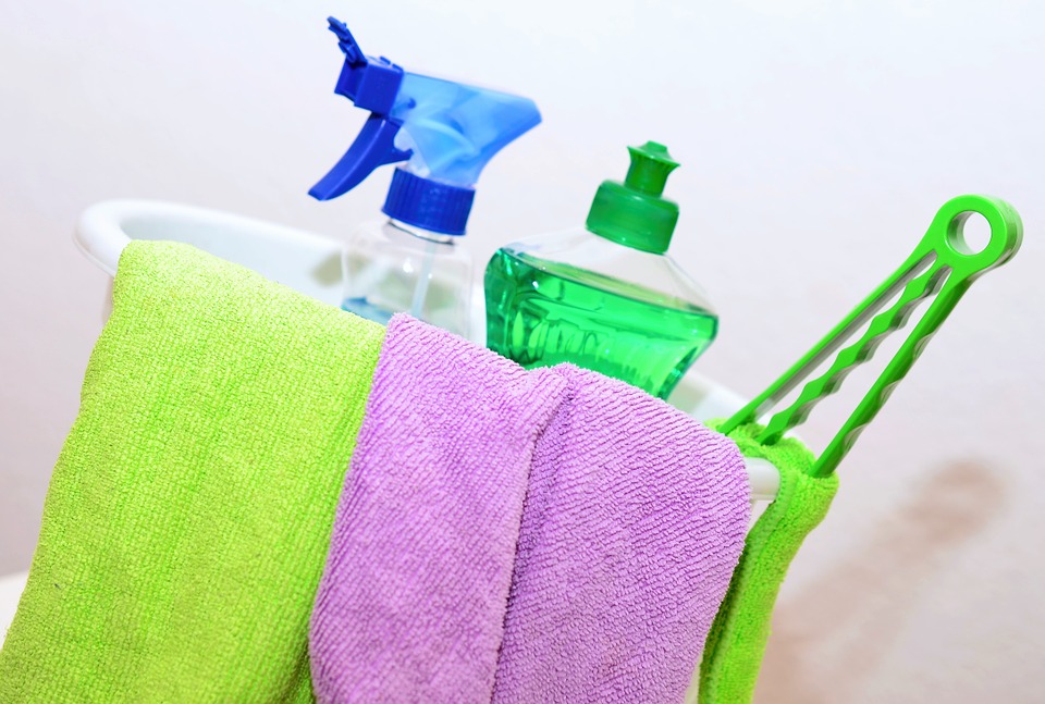 Towels, soap, and a spray bottle in a bucket