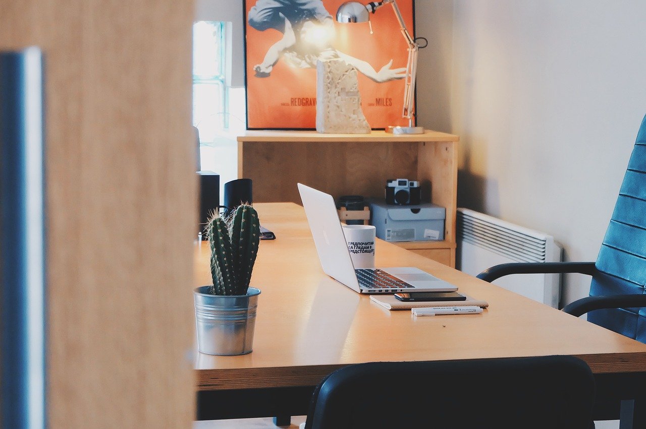 An office with a desk, computer, and chair