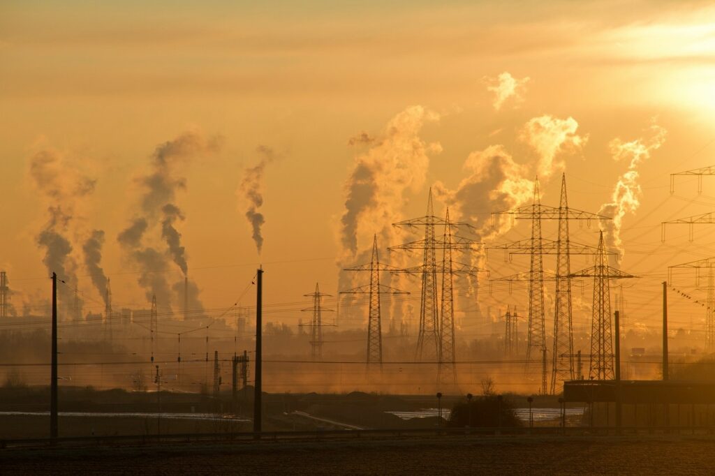 Yellow orange sky with smoke stacks