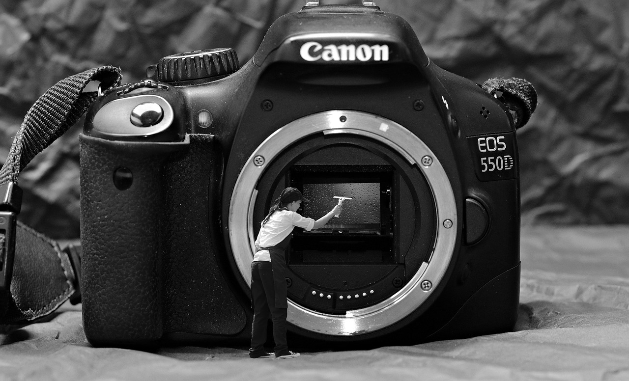 A person cleaning the lens of a camera