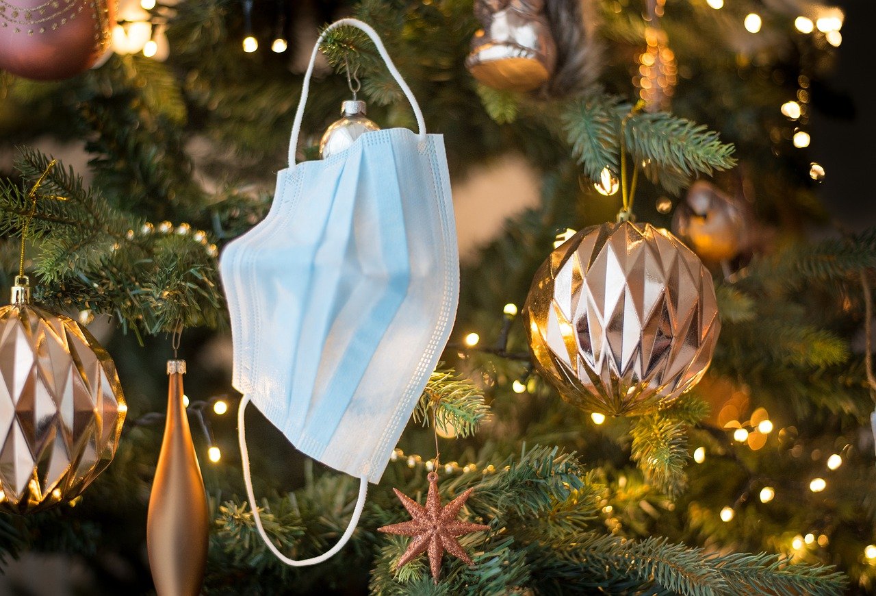 Face mask hanging in a Christmas tree.