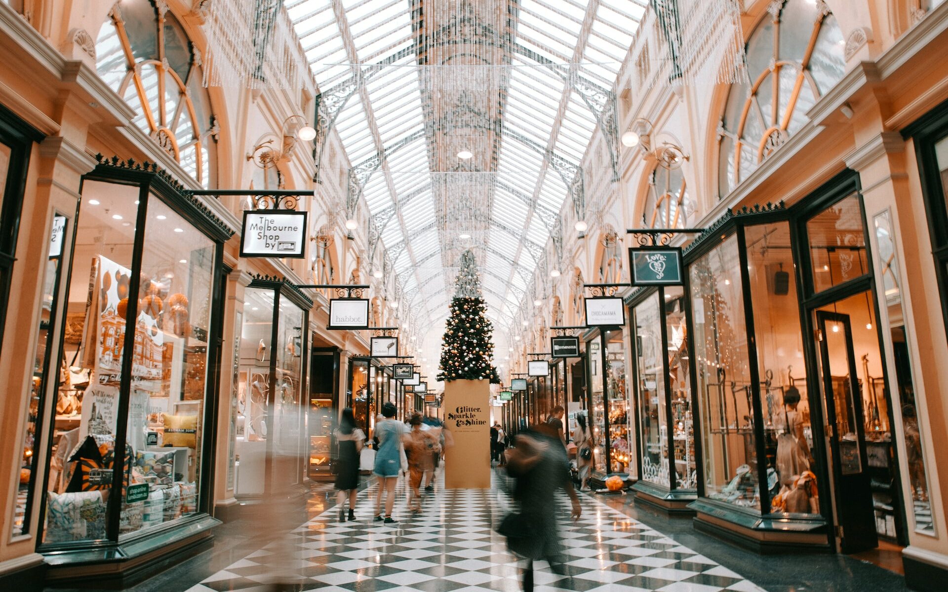 An open shopping mall with Christmas decorations decorating the place.