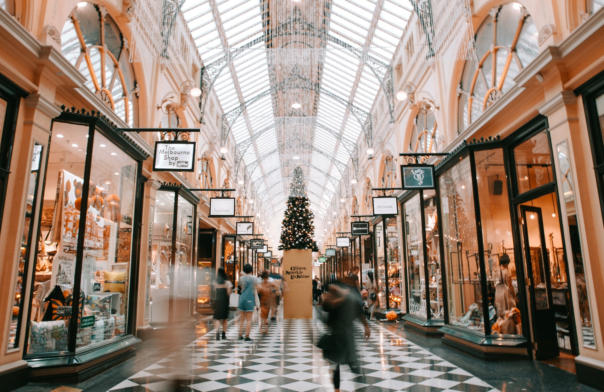 An open shopping mall with Christmas decorations decorating the place.