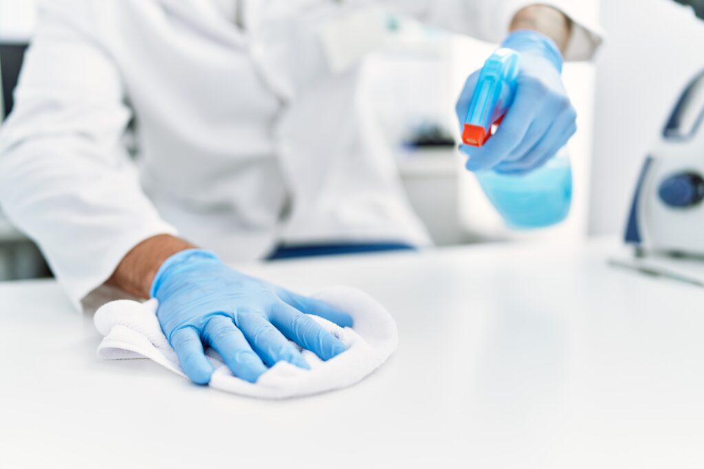 Person cleaning the table at laboratory