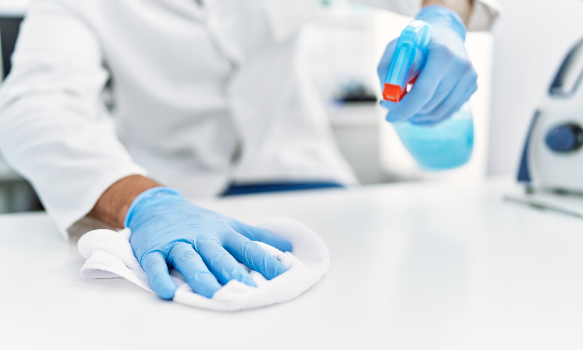 Person cleaning the table at laboratory